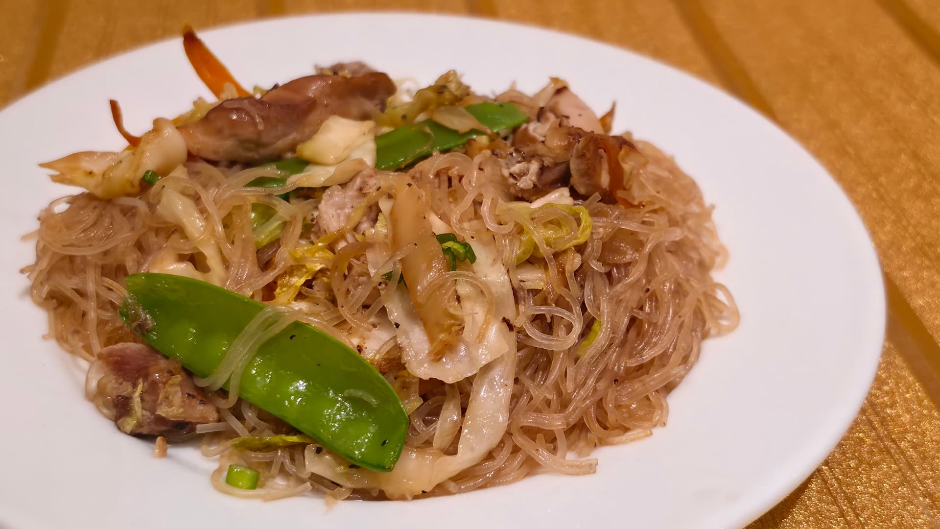 A plate of pancit — noodles, chicken and vegetables.